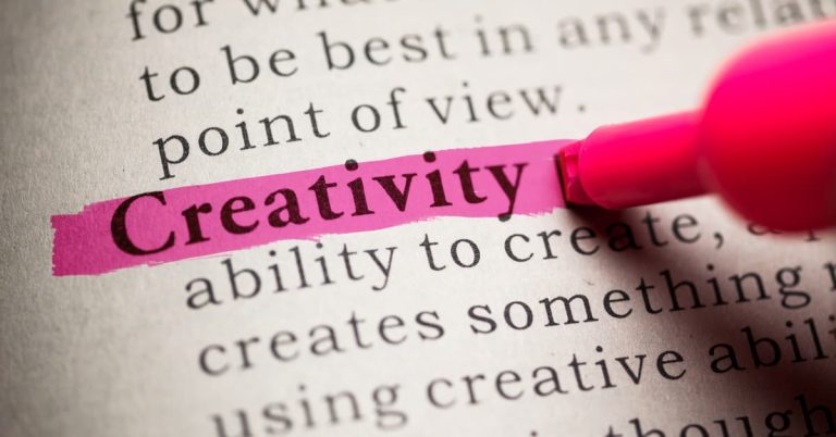 The word "creativity" in a dictionary, highlighted by a pink highlighter pen